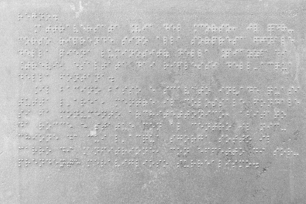 Website accessibility: close-up of a braille information sign in Rome